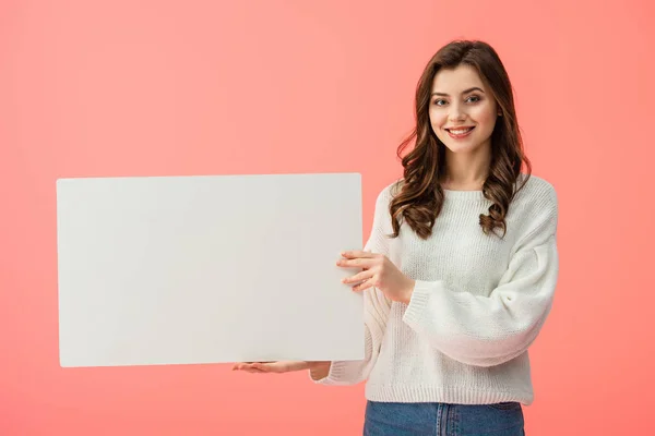 Smiling and beautiful woman holding blank placard with copy space isolated on pink — Stock Photo
