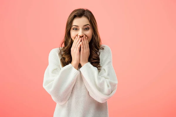 Surprised and beautiful woman in white sweater looking at camera isolated on pink — Stock Photo