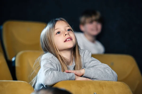 Selective focus of cute attentive child watching movie in cinema — Stock Photo