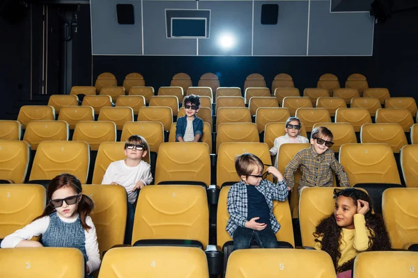 Cute children in 3d glasses sitting in cinema hall together — Stock Photo