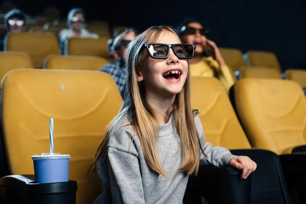 Happy excited child in 3d glasses watching movie in cinema — Stock Photo