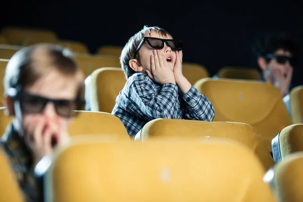 Selective focus of cute boy in 3d glasses watching movie and holding hands near face — Stock Photo