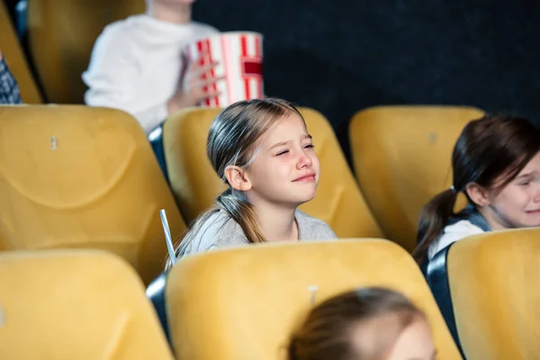 Upset worried children watching movie in cinema together — Stock Photo