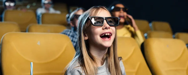 Panoramic shot of smiling laughing child in 3d glasses watching movie — Stock Photo