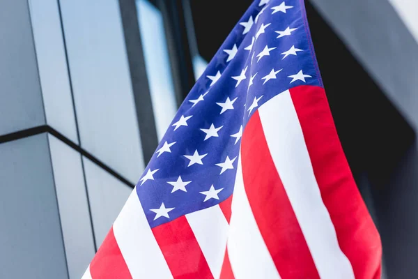 National american flag with stars and stripes near building — Stock Photo