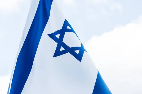 National israel flag with star of david against blue sky — Stock Photo