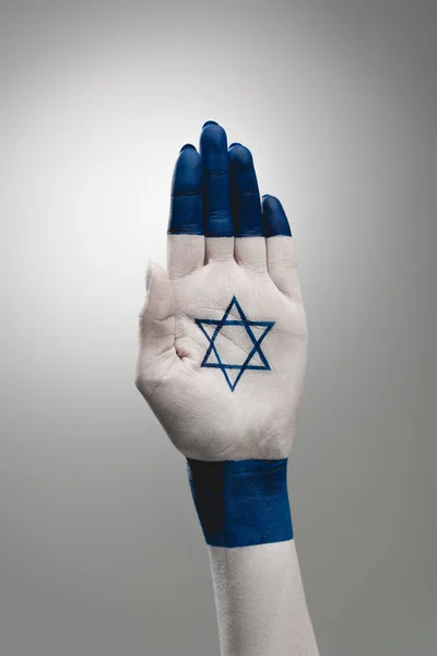 Cropped view of female hand with star of david on grey — Stock Photo