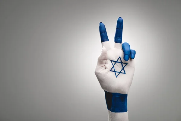 Cropped view of female hand with star of david showing peace sign on grey — Stock Photo