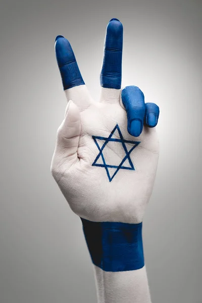 Cropped view of female hand with blue star of david showing peace sign on grey — Stock Photo