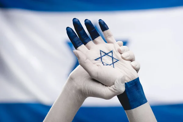 Cropped view of female hands with star of david  near flag — Stock Photo