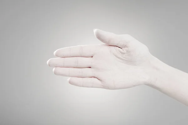 Cropped view of hand painted in white on grey — Stock Photo