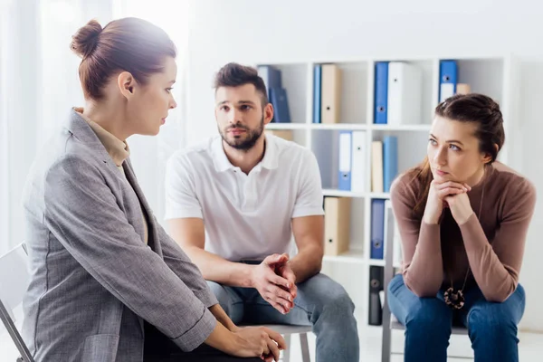 Women and man sitting on chairs during group therapy session — Stock Photo