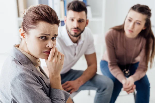 Depressed woman looking at camera during group therapy session — Stock Photo