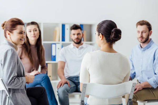 Group of people sitting in circle on chairs during support group session — Stock Photo