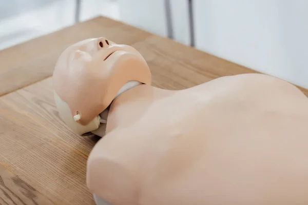 Cpr dummy for first aid training on wooden table — Stock Photo