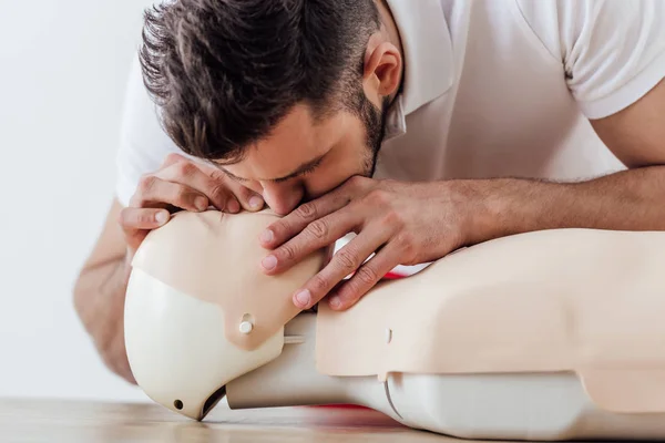 Homme utilisant bouche à bouche technique sur mannequin pendant la formation cpr — Photo de stock