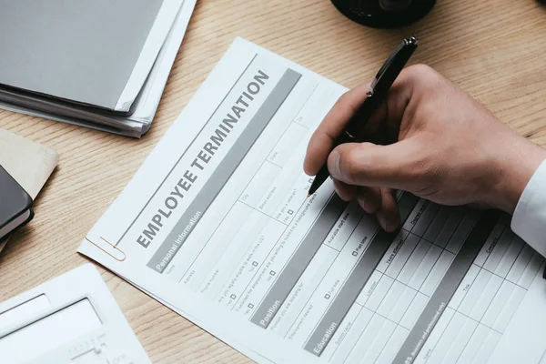 Cropped view of man filling in Employee Termination Form Contract Concept — Stock Photo