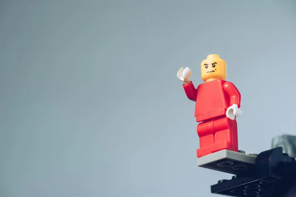 KYIV, UKRAINE - MARCH 15, 2019: red lego figure with angry face isolated on grey with copy space — Stock Photo