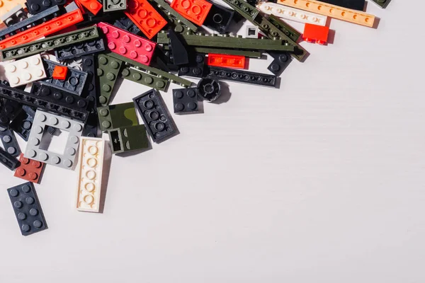 KYIV, UKRAINE - MARCH 15, 2019: top view of colorful scattered lego blocks isolated on white with copy space — Stock Photo