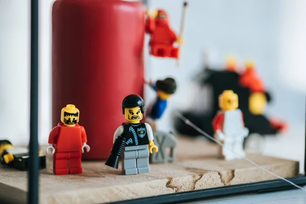 KYIV, UKRAINE - MARCH 15, 2019: selective focus of lego characters standing near candle with copy space — Stock Photo