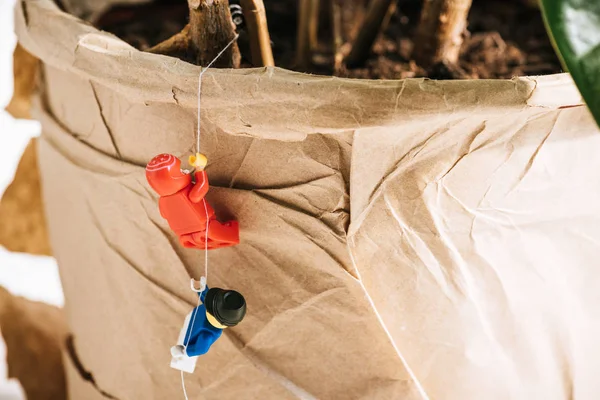 KYIV, UKRAINE - MARCH 15, 2019: close up view of red and blue plastic lego figurines climbing rope — Stock Photo