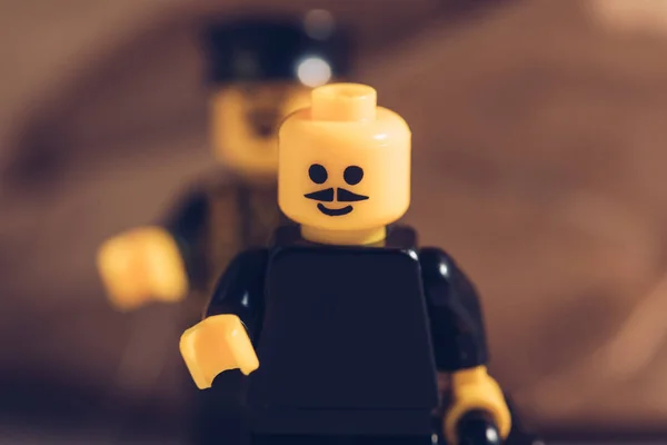 KYIV, UKRAINE - MARCH 15, 2019: selective focus of black lego figurine with moustache and smiley face — Stock Photo