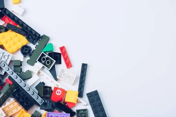 KYIV, UKRAINE - MARCH 15, 2019: top view of colorful scattered lego blocks isolated on white with copy space — Stock Photo