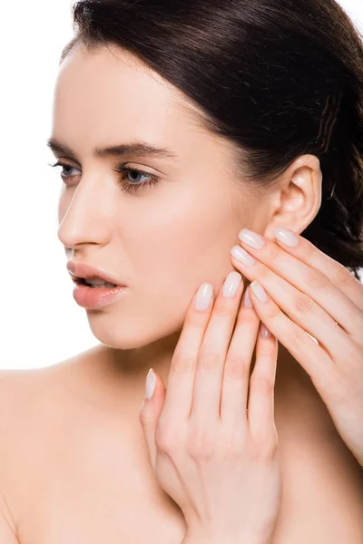 Close up of sad young woman touching skin isolated on white — Stock Photo