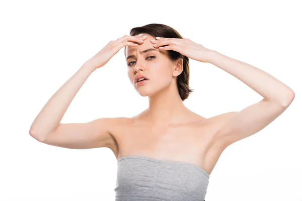 Attractive brunette girl pressing forehead isolated on white — Stock Photo