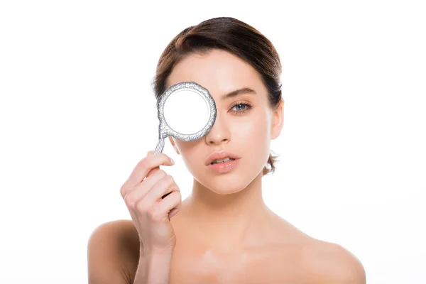 Attractive nude woman covering eye with mirror isolated on white — Stock Photo