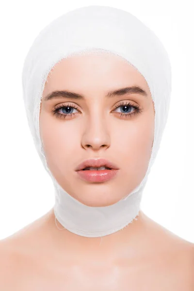 Attractive young woman with bandaged head looking at camera isolated on white — Stock Photo