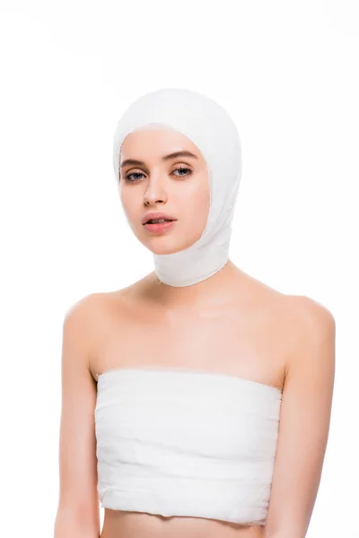 Beautiful woman with bandaged head and breast isolated on white — Stock Photo