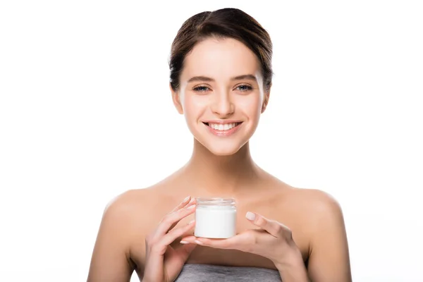 Cheerful girl holding container with cosmetic cream isolated on white — Stock Photo