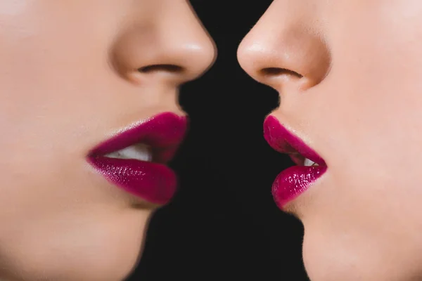 Cropped view of woman with crimson lips near mirror isolated on black — Stock Photo