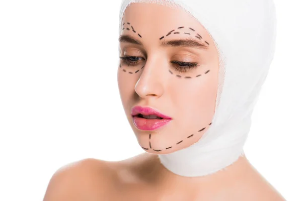 Pretty young woman with bandaged head and marks on face isolated on white — Stock Photo
