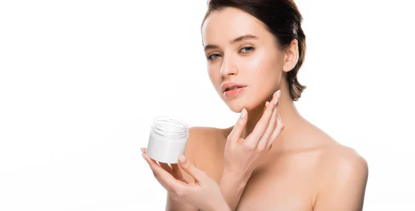 Panoramic shot of pretty woman holding container with cosmetic cream and looking at camera isolated on white — Stock Photo