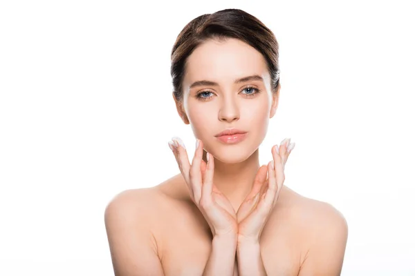 Naked young woman with face cream in fingers looking at camera isolated on white — Stock Photo