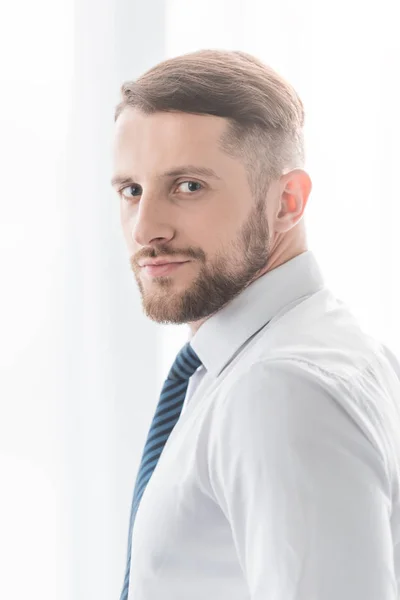 Handsome and successful bearded man looking at camera at home — Stock Photo