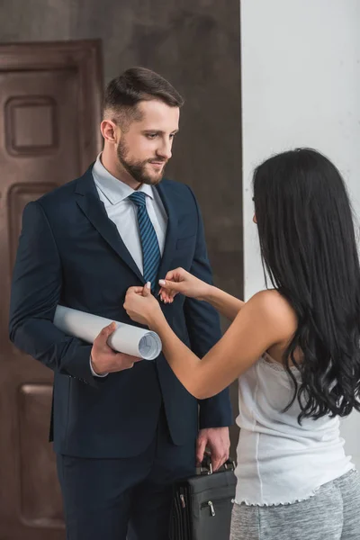 Brunette young woman touching formal wear of handsome man — Stock Photo