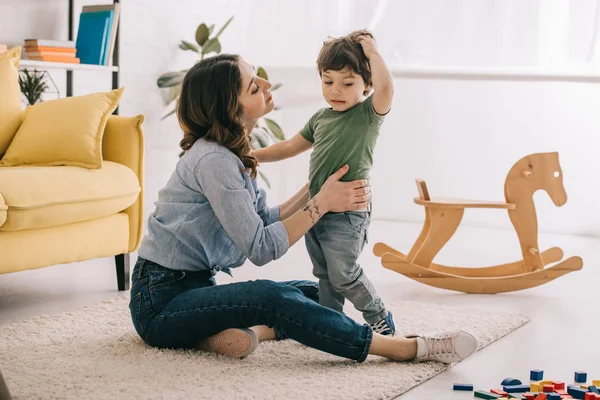 Mother and son playing together in living room — Stock Photo