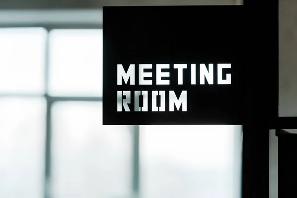 Black metallic board with meeting room lettering in modern office — Stock Photo