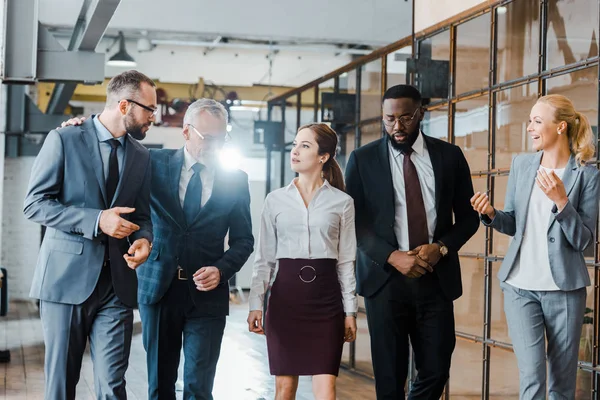 Multicultural group of businessmen and businesswomen standing in office — Stock Photo