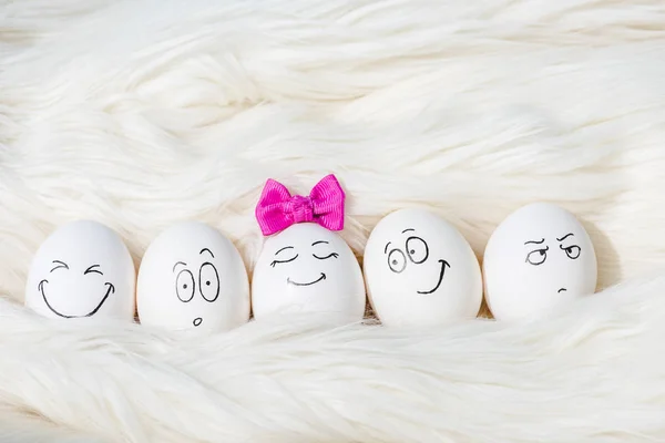 Eggs with various face expressions on White Fur — Stock Photo