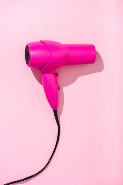 Top view of hair dryer on pink with copy space — Stock Photo