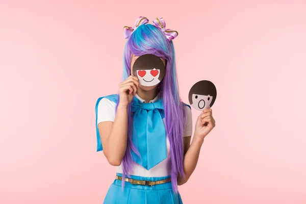 Anime girl in purple wig holding emoticons isolated on pink — Stock Photo