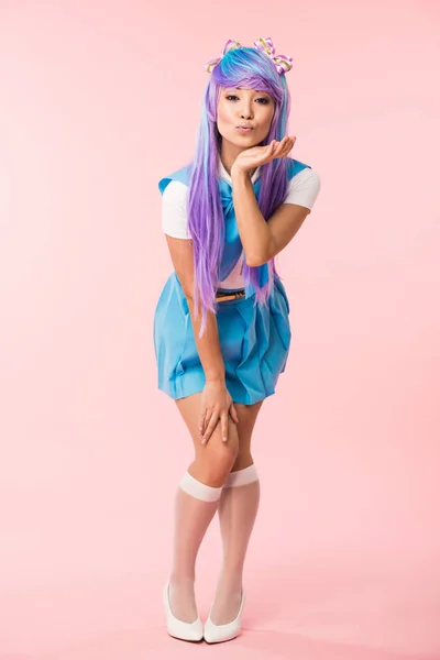 Full length view of asian anime girl in purple wig posing with kissing face expression on pink — Stock Photo