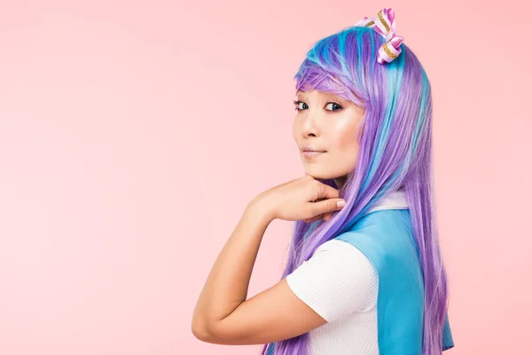 Pretty asian anime girl in purple wig looking at camera isolated on pink — Stock Photo