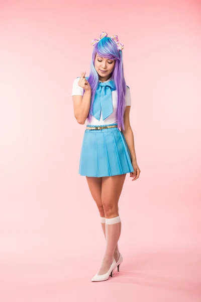 Full length view of anime girl in blue skirt showing heart sign on pink — Stock Photo