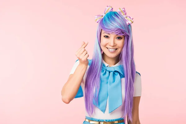 Excited asian anime girl showing heart sign isolated on pink — Stock Photo