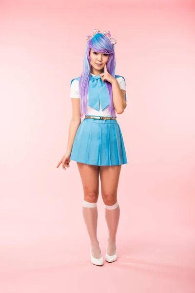 Full length view of otaku girl in purple wig smiling on pink — Stock Photo